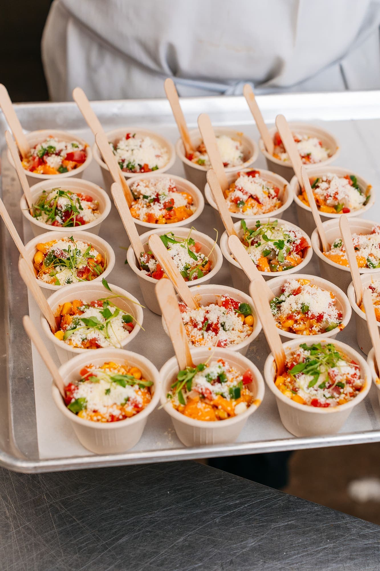 Street corn cups topped with cotija and chile