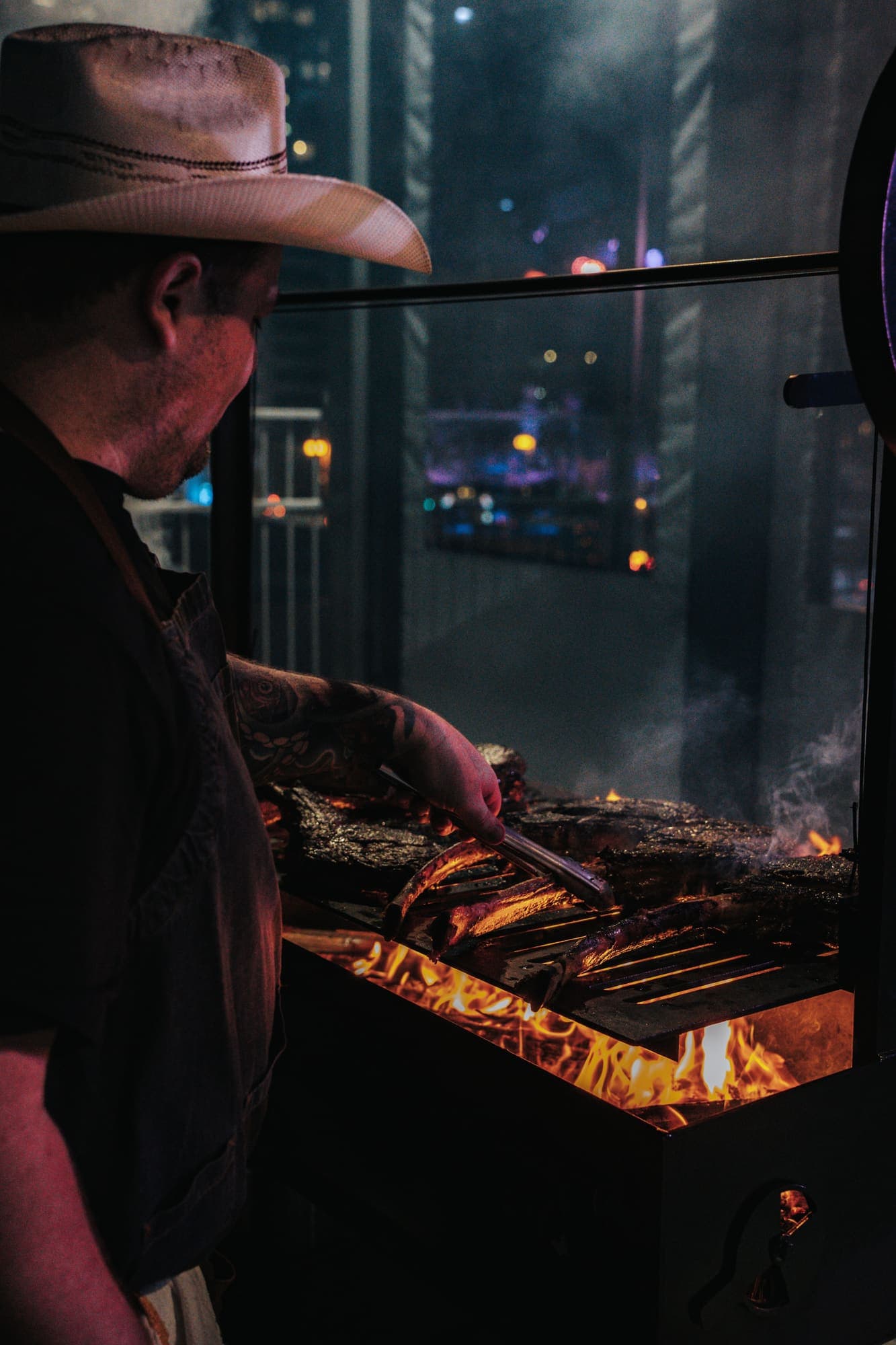 Chef tending whole animals over an open fire